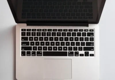 An open silver laptop viewed from above, showing its black keyboard and trackpad. of a digital marketing strategist in Kannur, Kerala.
