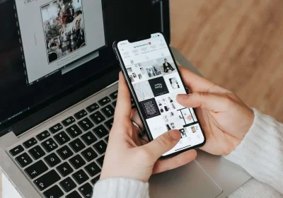 An open silver laptop and phone viewed from side, showing its black keyboard and trackpad. of a digital marketing strategist in Kannur, Kerala working